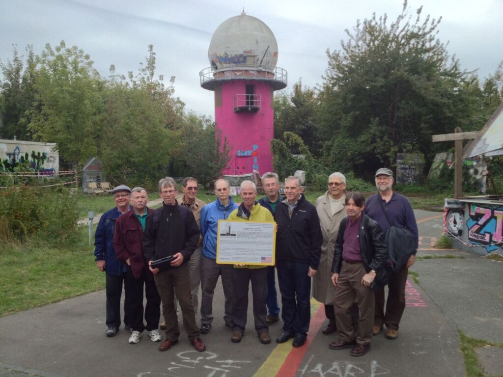 Lew McDaniel and fellow Berlin veterans standing in front of the listening tower they worked at in Teufelsberg, West Berlin