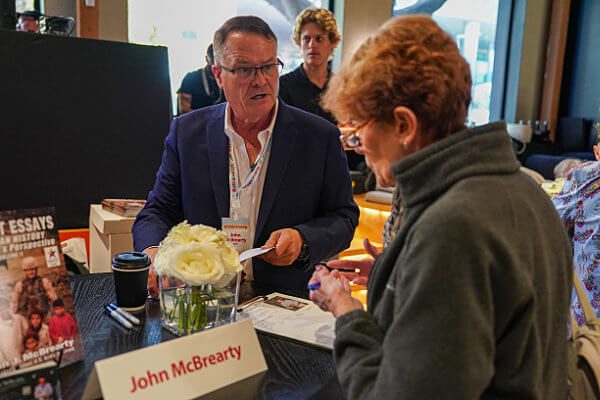 Army veteran and author John McBrearty signs his book for a fan