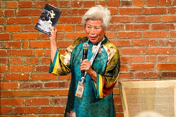 Le Ly Haslip holding her book up
