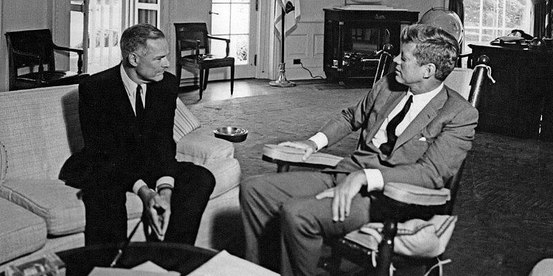 President Kennedy in a rocking chair and Ambassador Henry Cabot Lodge on a couch in the Oval Office
